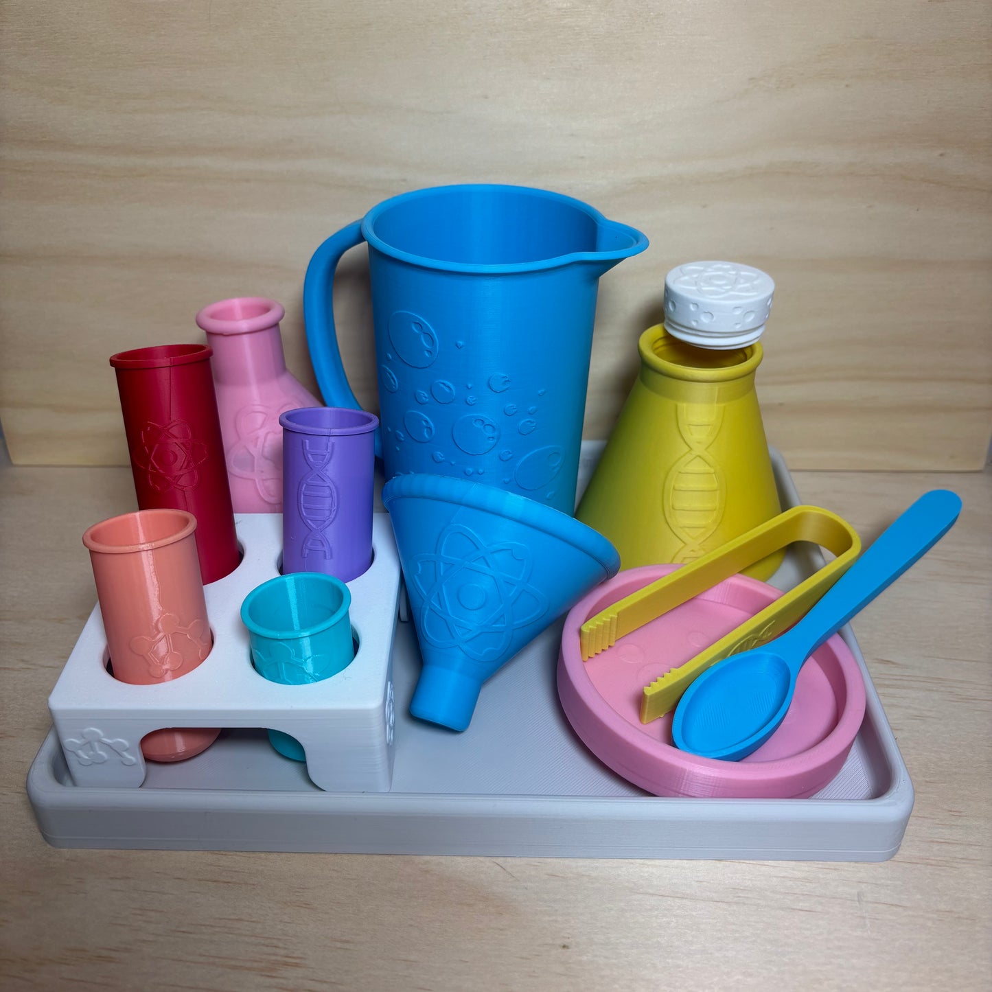 Colourful 3D printed Little Scientist sensory play set with test tubes, science flask, pouring jug, funnel, spoon, tongs and sensory tray