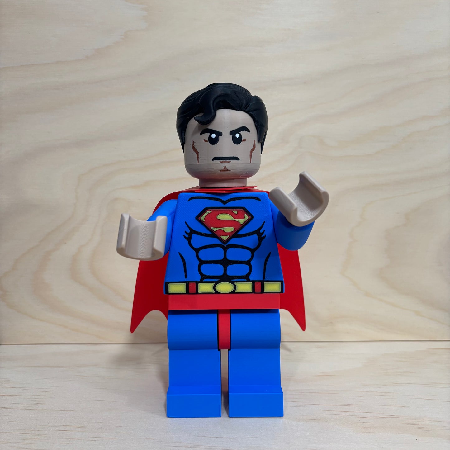 3D printed Superman Brickman Figure wearing the classic blue suit and red cape.