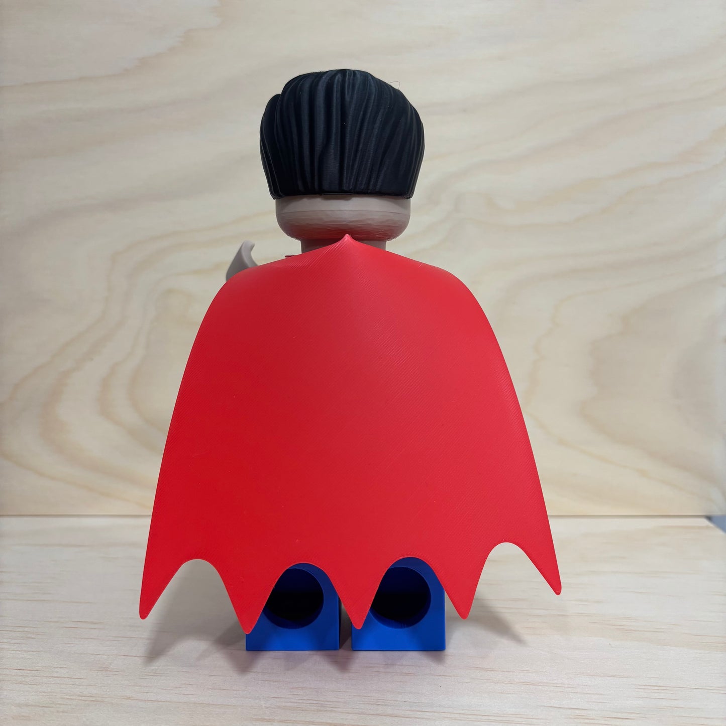 3D printed Superman Brickman Figure wearing the classic blue suit and red cape.