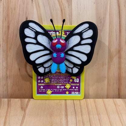 3D printed 0012 Butterfree Pokémon Card Display featuring a detailed Butterfree figure mounted on a Pokémon-inspired trading card backdrop.