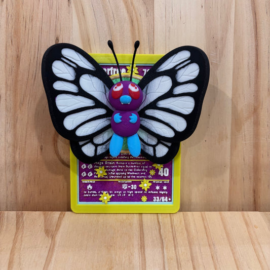 3D printed 0012 Butterfree Pokémon Card Display featuring a detailed Butterfree figure mounted on a Pokémon-inspired trading card backdrop.