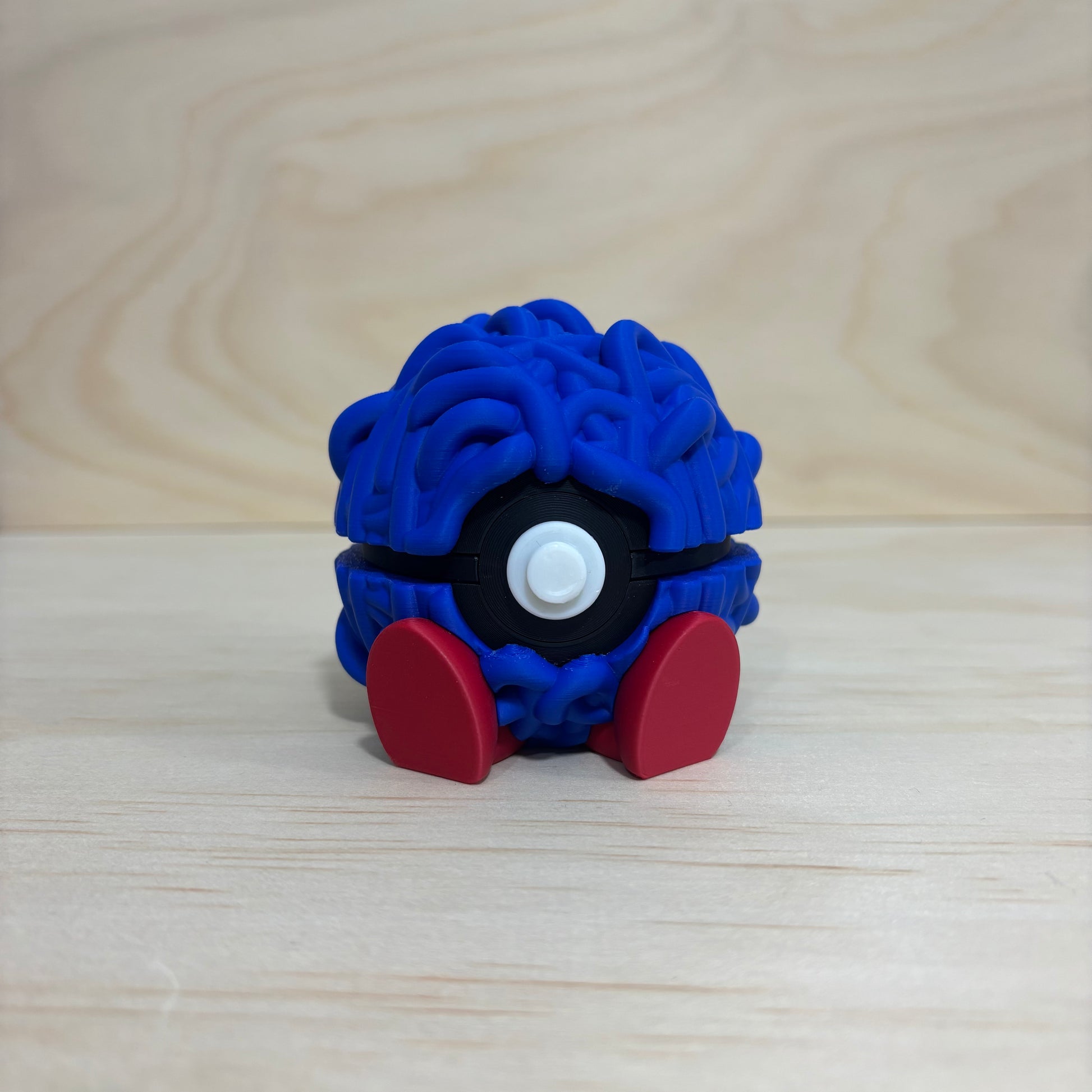 3D printed 0114 Tangela Poké Ball collectible with tangled blue vines, black and white centre button and red feet