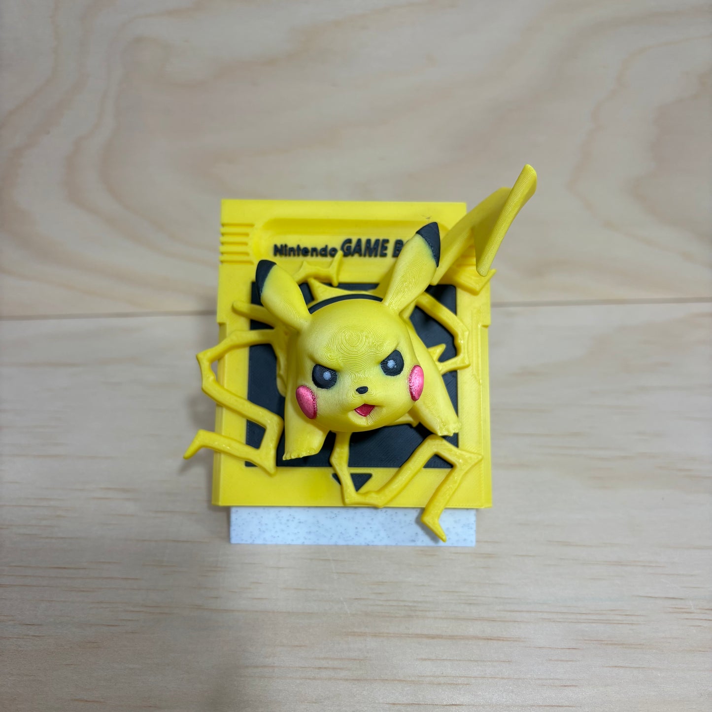 3D printed 0025 Pikachu Game Boy cartridge-inspired display featuring Pikachu bursting through a retro handheld game cartridge with lightning effects.