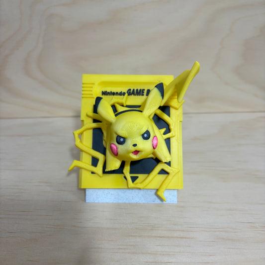 3D printed 0025 Pikachu Game Boy cartridge-inspired display featuring Pikachu bursting through a retro handheld game cartridge with lightning effects.