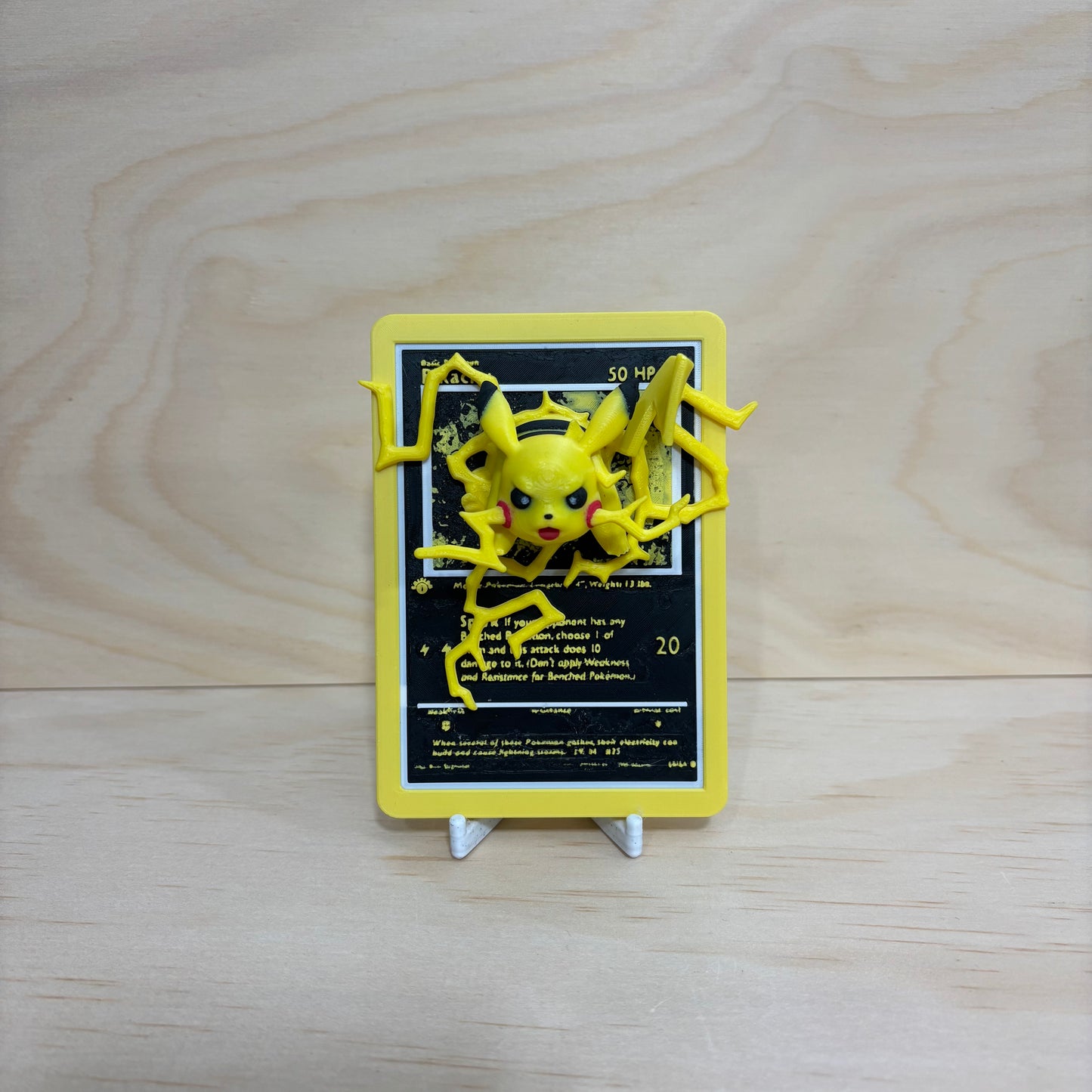 3D printed 0025 Pikachu Pokémon card display featuring Pikachu bursting through a Pokémon-inspired trading card with lightning effects.