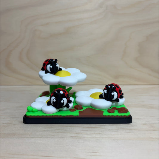 3D printed Mini Pal Ladybug Garden play set featuring three flexi ladybugs on colourful flowers.